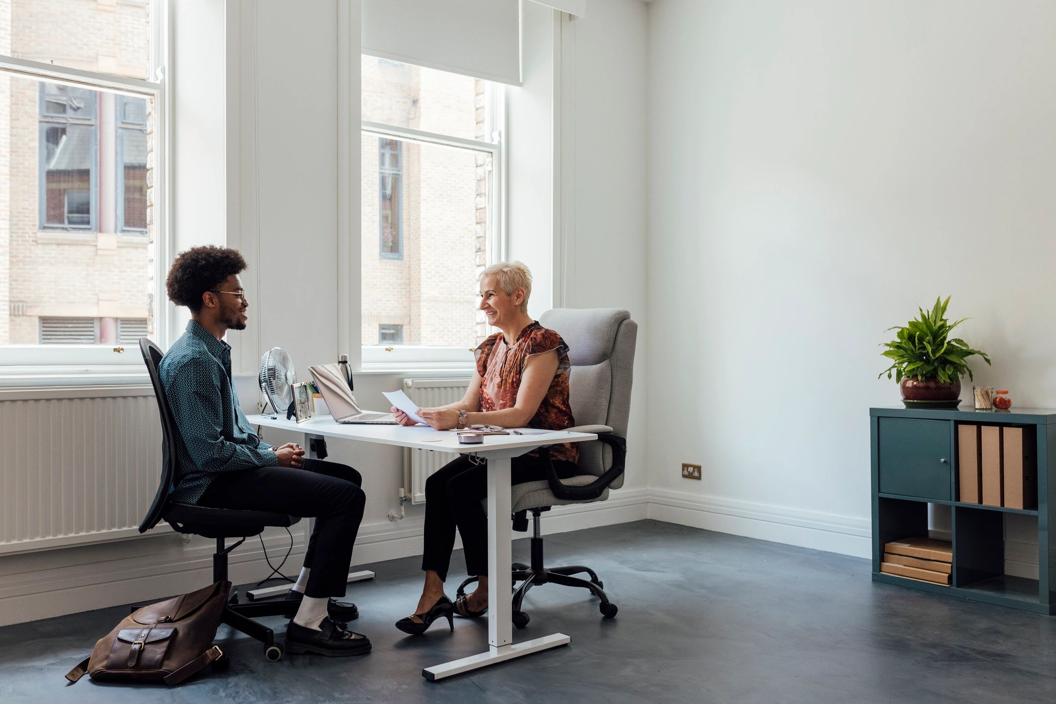 Coach and client in a focused one-on-one conversation at a desk